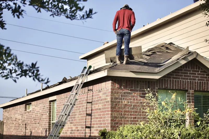 Professional roofer working on a residential roof in Rockford